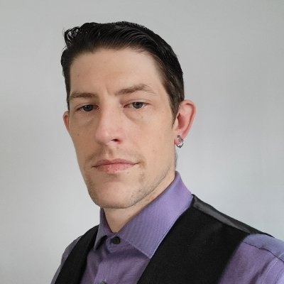 Jon Williams in a purple shirt and black vest